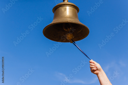 Brass Bell Hand closeup ringing notice instrument.