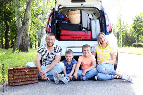 Beautiful family near car