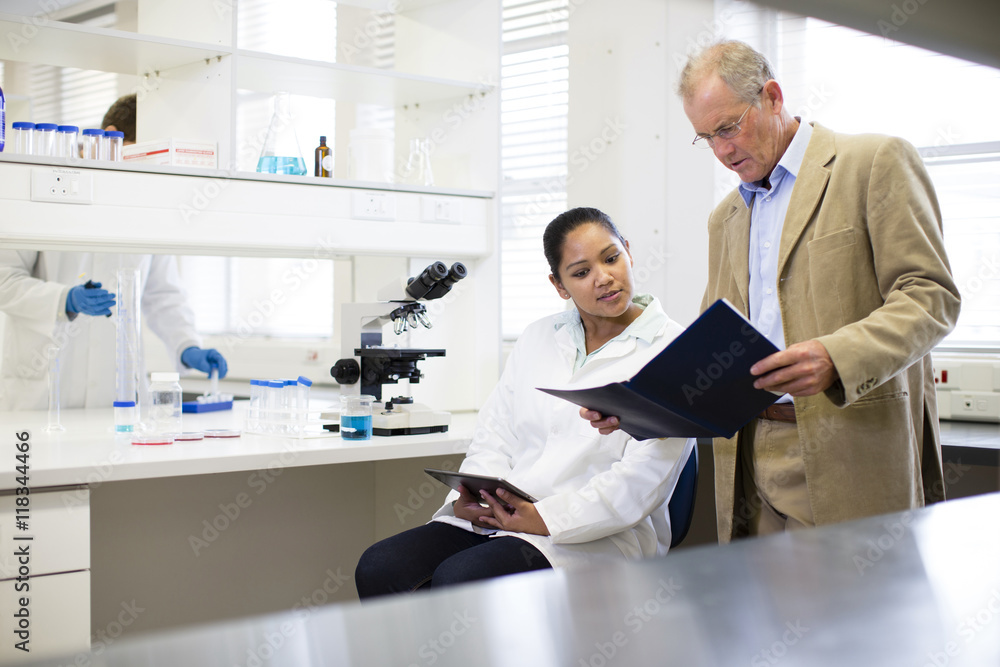 Businessman and scientist talking in laboratory Businessman and scientist talking in laboratory