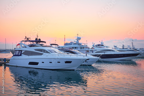 Extra Large Luxury yachts rest in the port at sunset