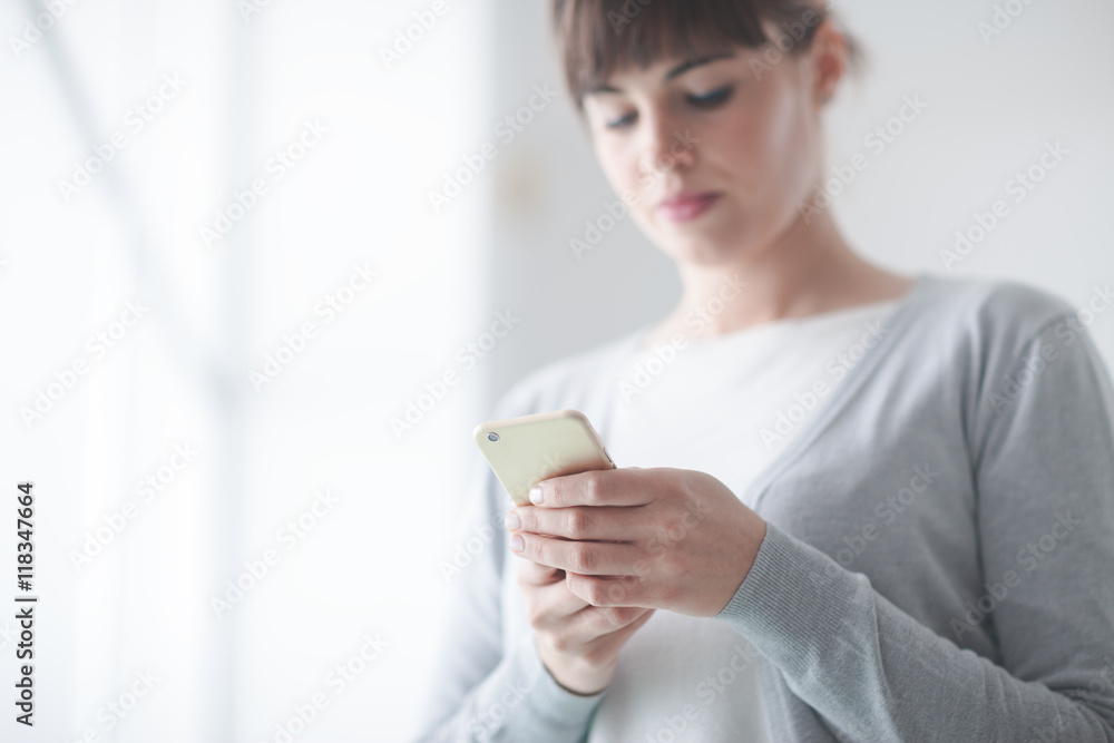 Young woman text messaging with her mobile Young woman text messaging with her mobile