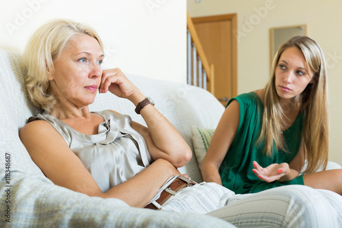 Картината върху платно Upset woman and  mature mother having conflict