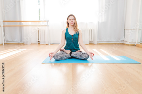 Young caucasian woman doing breathing exercises in lotus asana