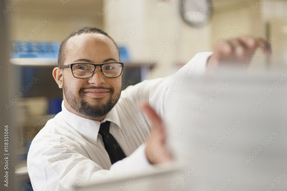 Mixed race server with down syndrome working in restaurant Mixed race server with down syndrome working in restaurant