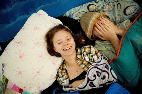 Couple laughing in camping tent photo