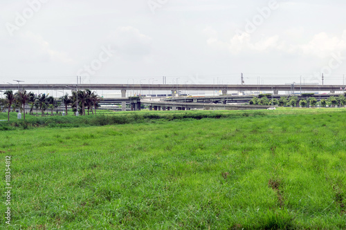 Highway or elevated expressway with a grass foreground in Bangkok Thailand.