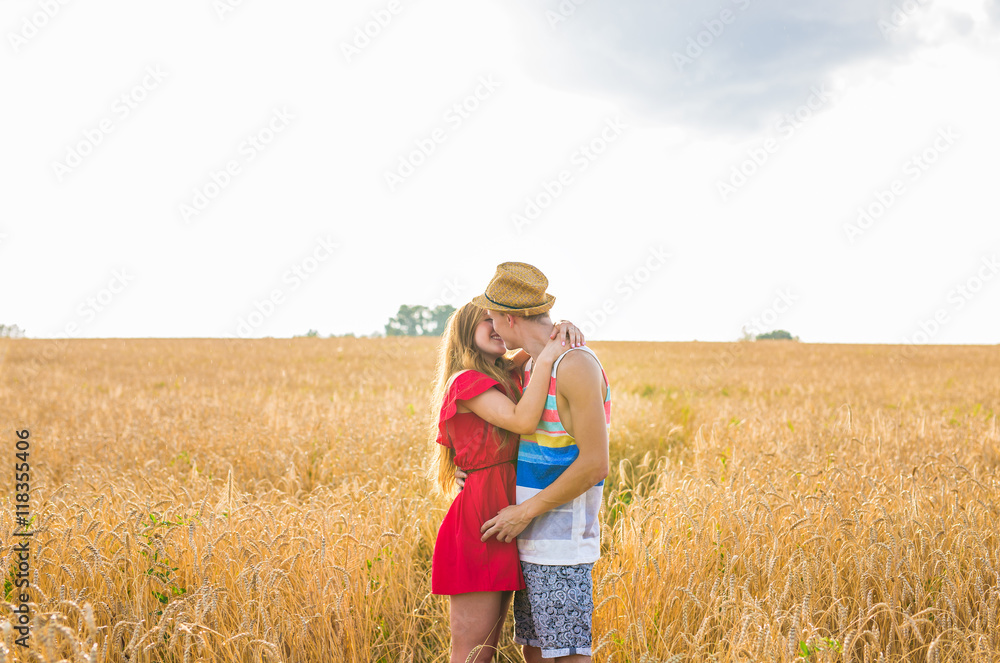 Stunning sensual portrait of young stylish fashion man and woman posing in field