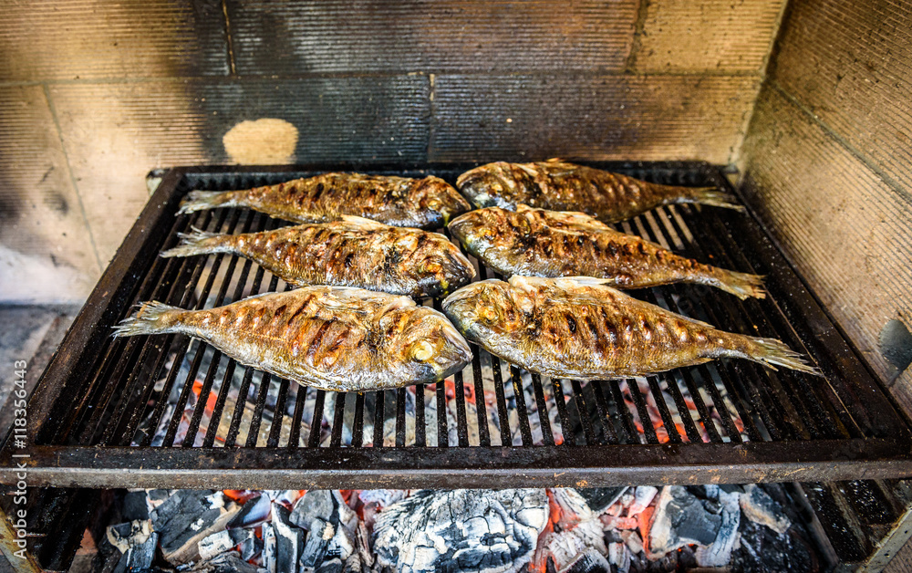 Preparing Fish on the charcoal grill.