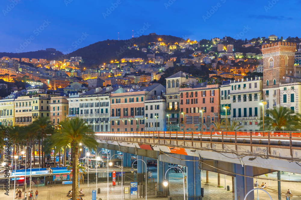 Aerial view of old town, highway and boulevard at night, Genoa, Italy.