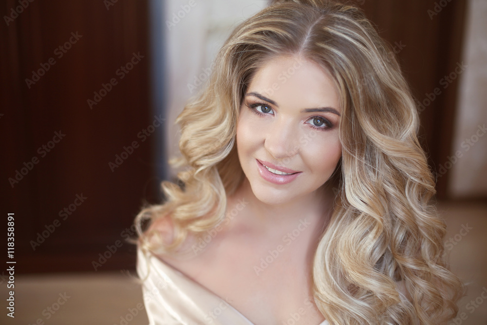 Long curly hair. Beautiful blond happy smiling bride girl lookin Long curly hair. Beautiful blond happy smiling bride girl lookin