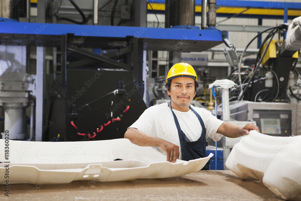 Worker smiling in manufacturing plant Worker smiling in manufacturing plant