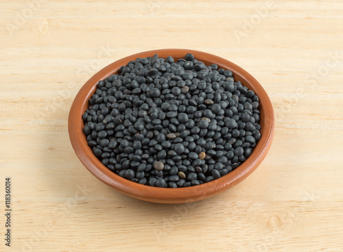 Black beluga lentils in a bowl on a table.