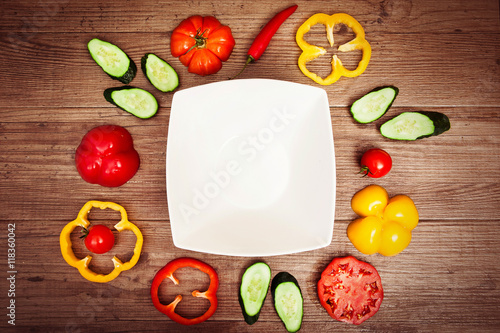 Organic healthy food background. fresh, delicious vegetables. Horizontal. Square white plate at center. Horizontal