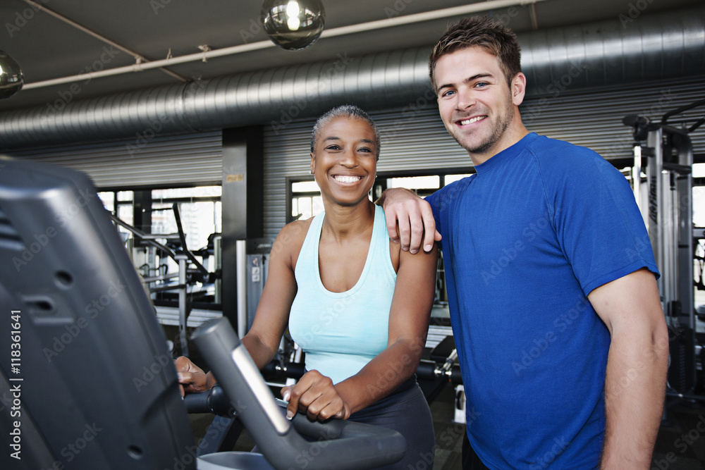 Woman with personal trainer in health club Woman with personal trainer in health club