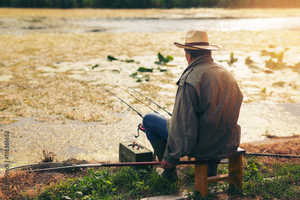 Senior man fishing on a freshwater lake Senior man fishing on a freshwater lake