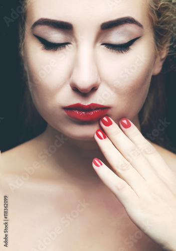 Beautiful model with make-up, red lips and manicure
