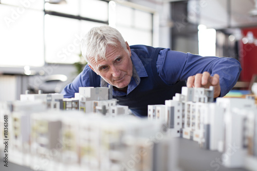 Senior architect examining model