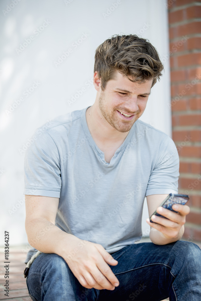 Man using cell phone outdoors Man using cell phone outdoors