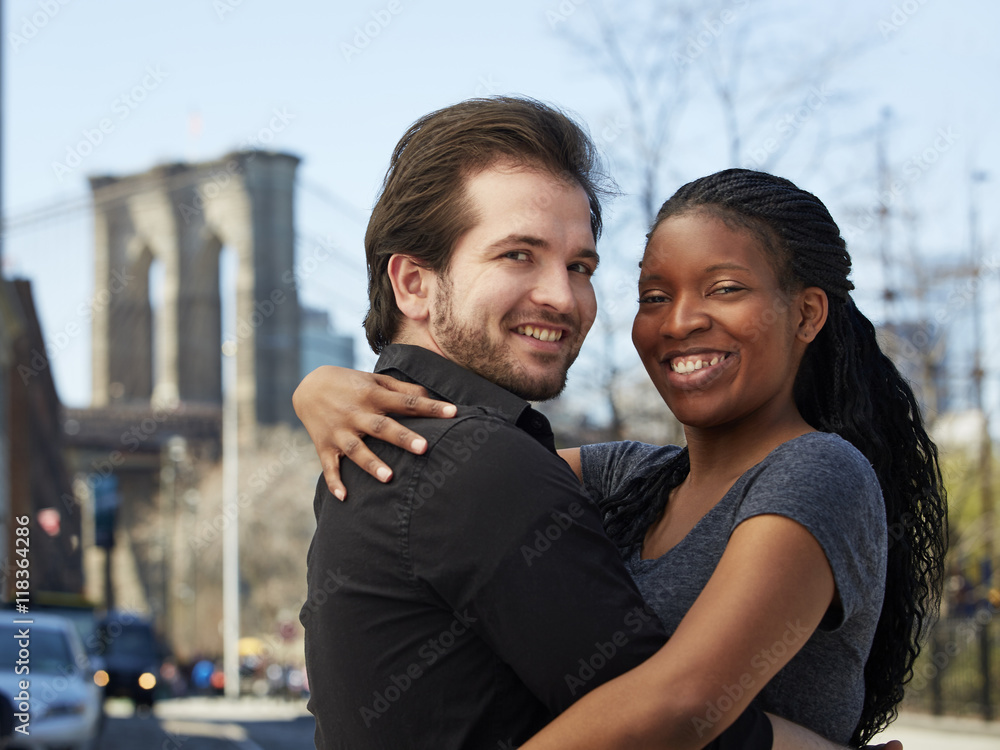 Smiling couple hugging in city Smiling couple hugging in city