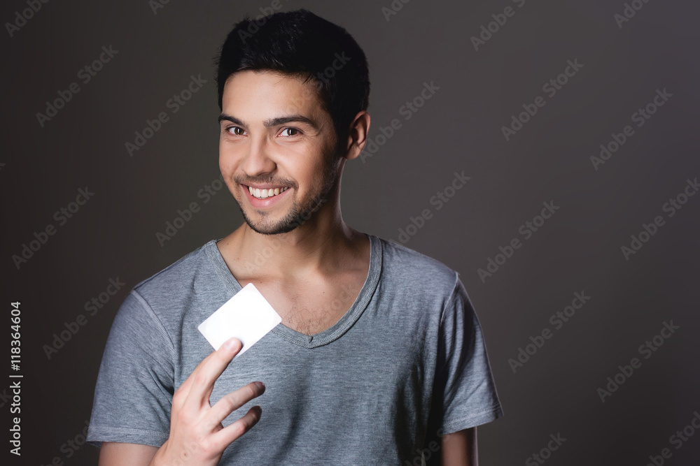 Portrait of a normal boy smiling over grey background / Attracti Portrait of a normal boy smiling over grey background / Attracti
