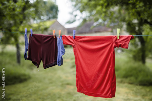 House of little football player. Boy’s sport outfit on drying line outdoor, © MariaBobrova