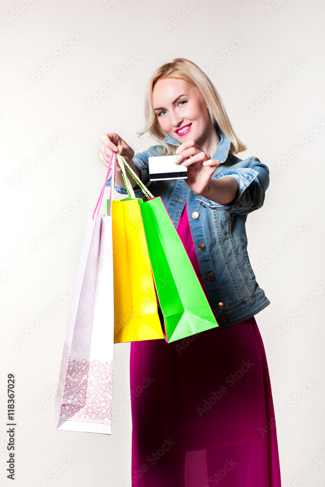 Smiling girl with shopping bags. credit card in the hands Smiling girl with shopping bags. credit card in the hands