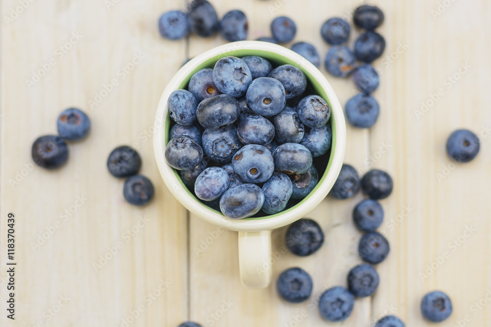 Mug filled with blueberries on white background. Mug filled with blueberries on white background.