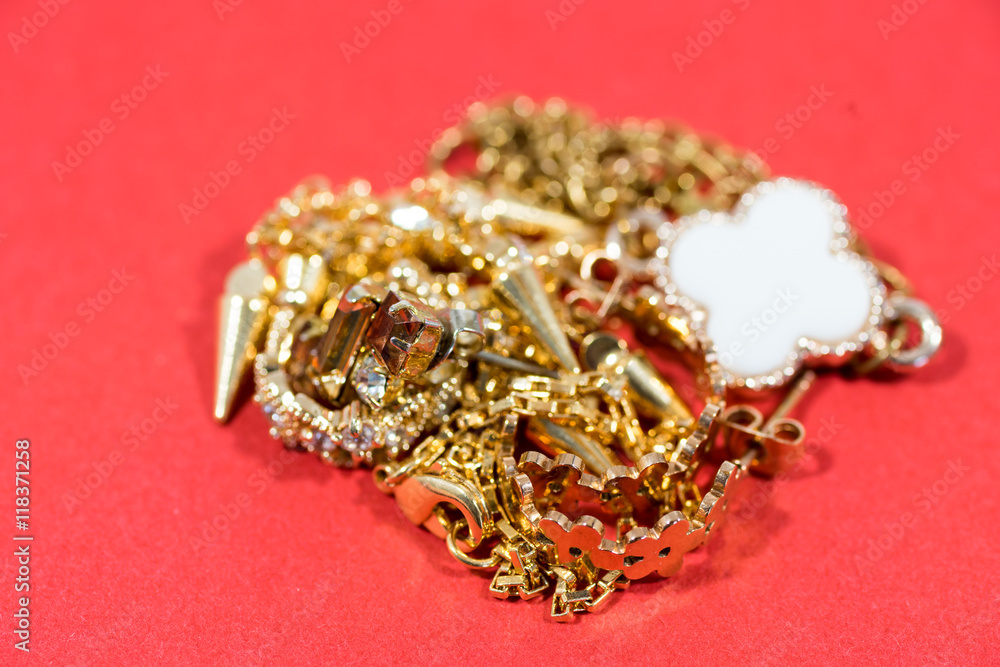Golden jewelry on the red background Golden jewelry on the red background