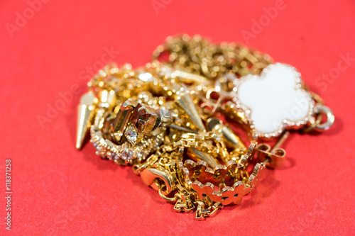 Golden jewelry on the red background