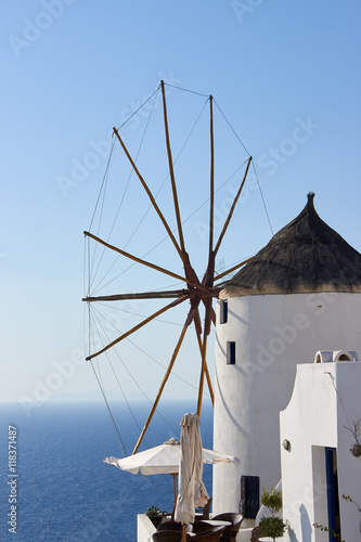 The white old mill on a background of blue sky and blue sea in the town of Oia on Santorini island in Greece 