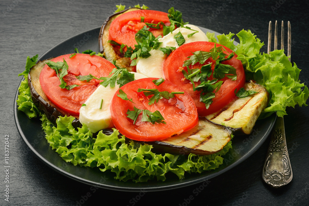 Appetizer - grilled eggplants with mozzarella and tomatoes.