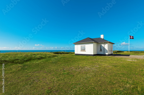 White house in the meadows by the sea