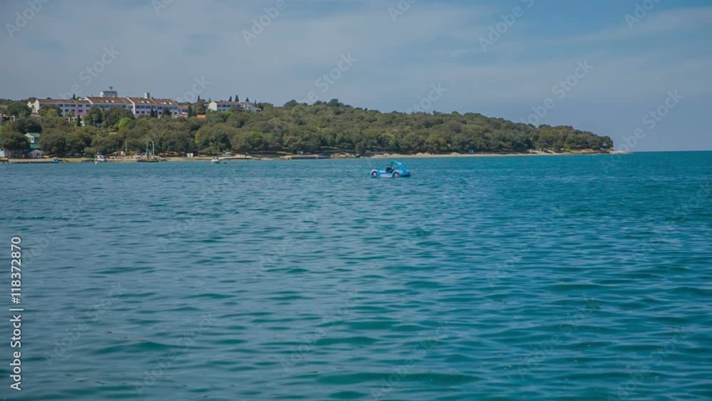 Small boat is sailing in the sea very slowly and peacefully. It is a beautiful and warm sunny day. Wide-angle shot.
Small boat is sailing in the sea very slowly and peacefully. It is a beautiful and warm sunny day. Wide-angle shot.