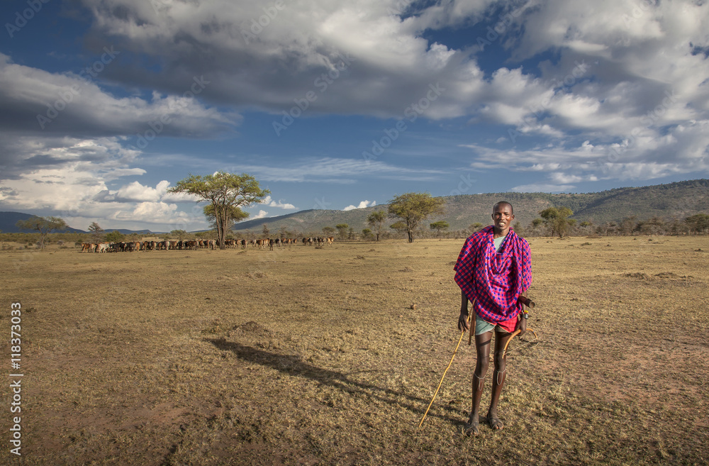 Black man in traditional clothing standing in remote field Black man in traditional clothing standing in remote field