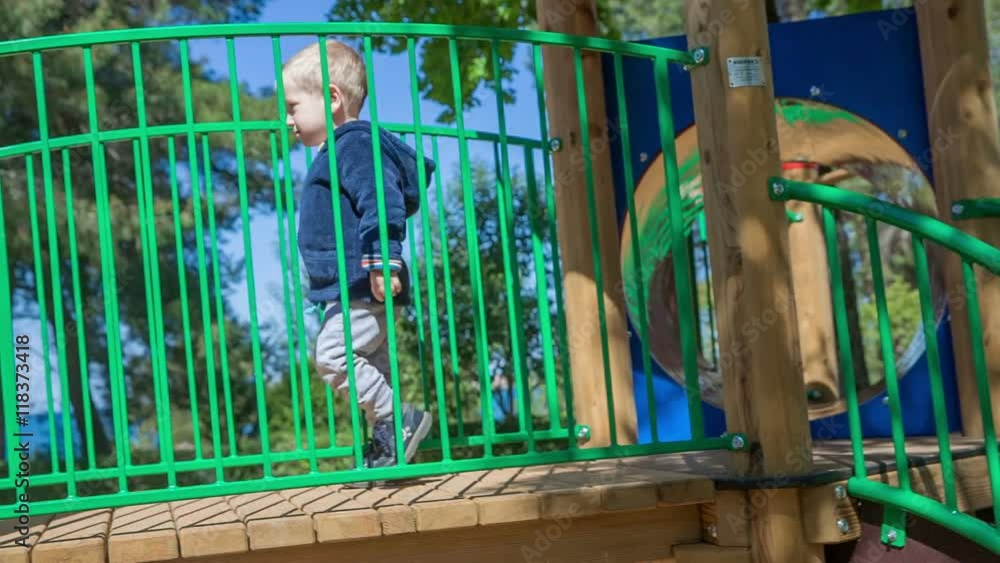 A Boy Is Going Up The Stairs To Go Down A Slide He Looks Very Excited a-boy-is-going-up-the-stairs-to-go-down-a-slide-he-looks-very-excited