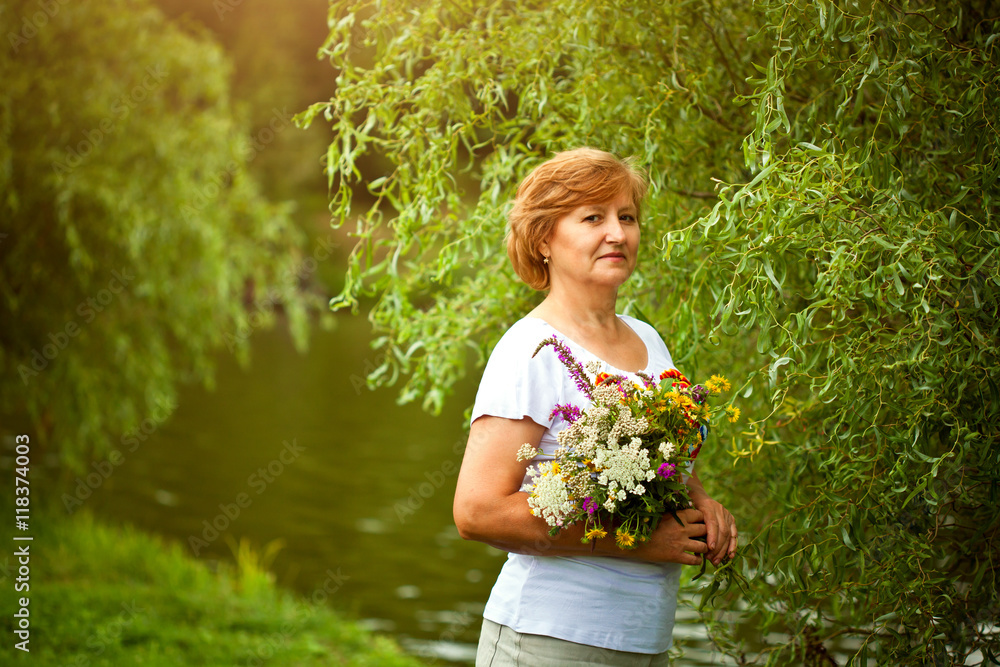 Middle-aged woman with flowers Middle-aged woman with flowers