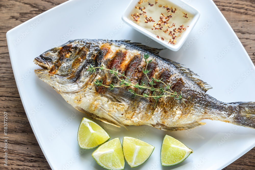 Grilled Dorade Royale Fish on the plate Grilled Dorade Royale Fish on the plate