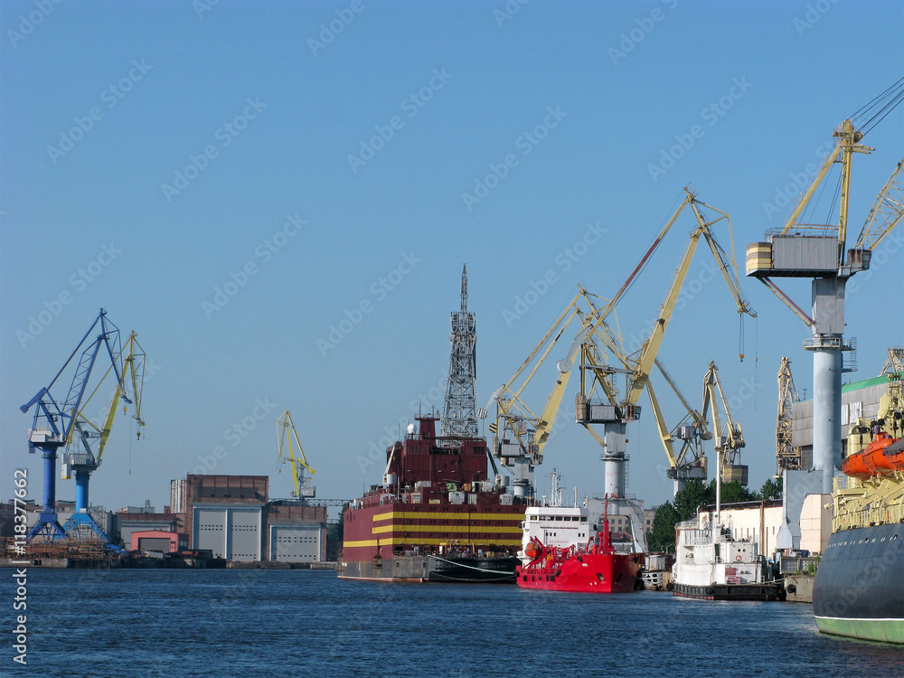 Fototapeta premium Cargo port with cargo handling cranes, warehouses and ships