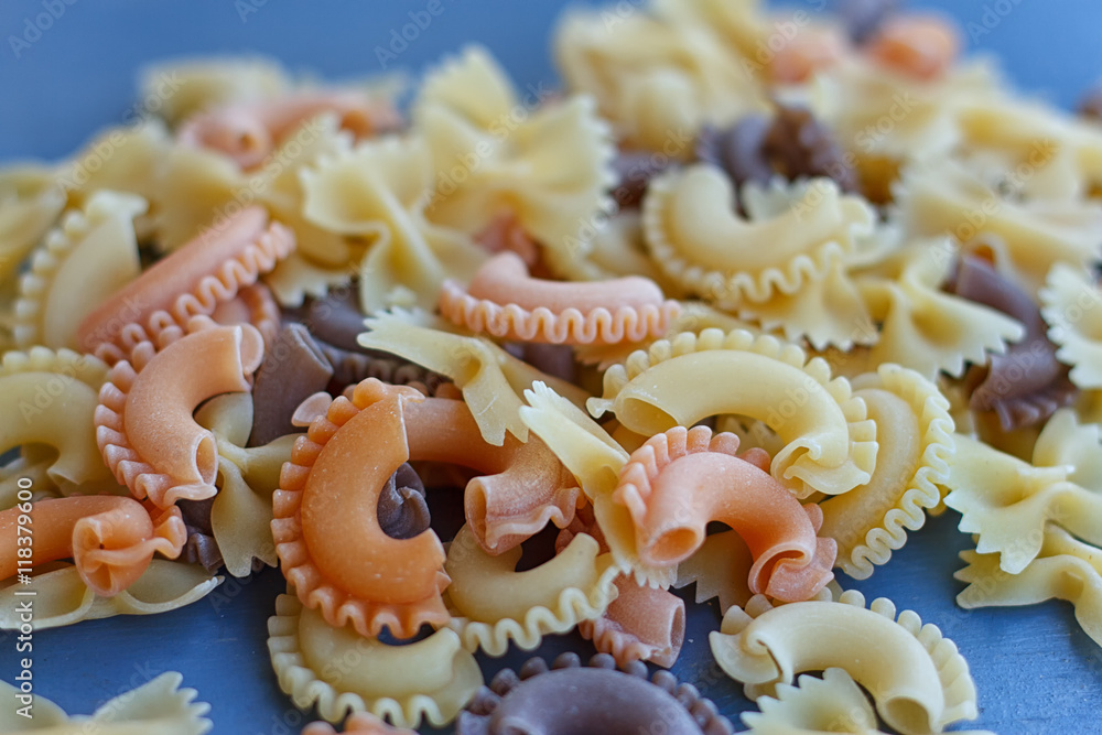 Multicolored different shapes of uncooked pasta Multicolored different shapes of uncooked pasta