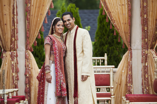 Smiling Indian couple in traditional wedding clothing