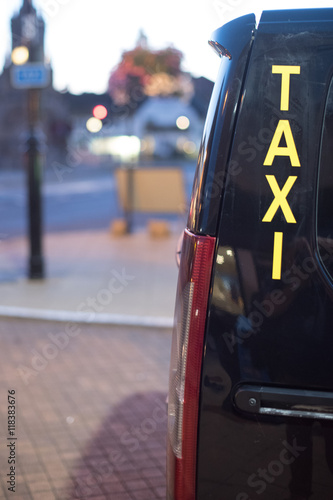 Фотография minicab unlicensed taxi waiting at rank