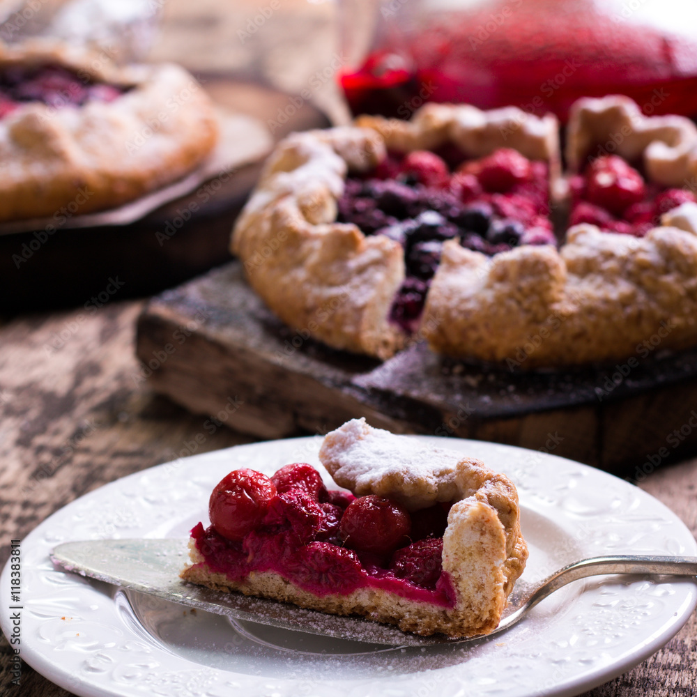 Blueberry,cherry,raspberry and blackcurrant galette on w wooden background. Blueberry,cherry,raspberry and blackcurrant galette on w wooden background.