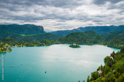 Bled island and boats on Lake Bled with cloudy sky in Slovenia