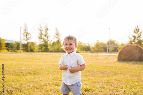 Little boy in the countryside. Toddler playing active games outdoors. Childhood, carefree, children's games, boy, fresh air, active children's rest. The concept of childhood.