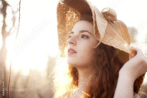 Hispanic woman wearing sun hat outdoors photo