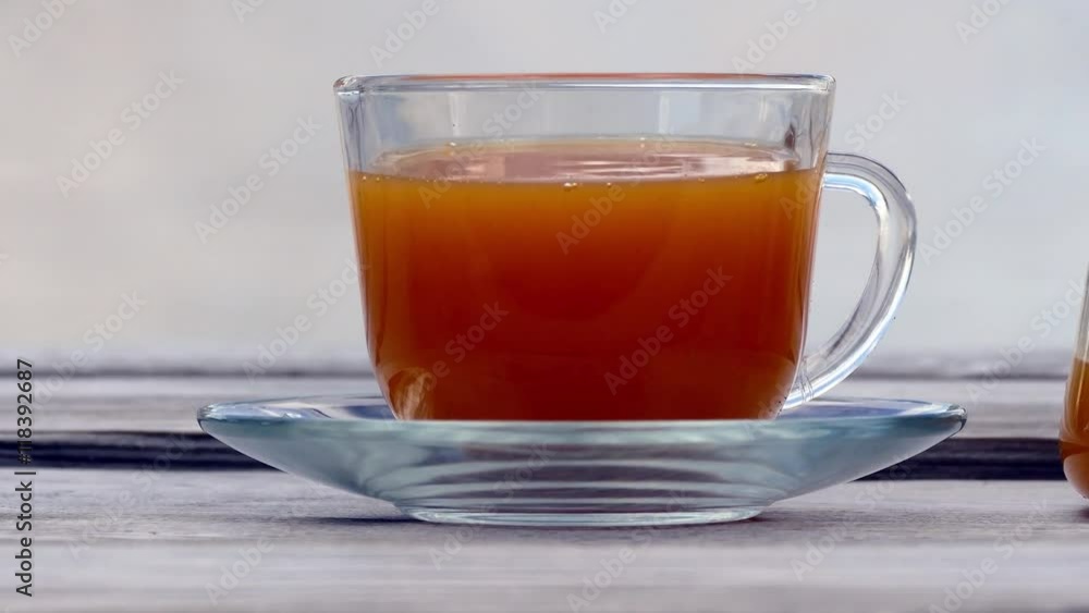 Tea with sea buckthorn and honey on cafe background Tea with sea buckthorn and honey on cafe background