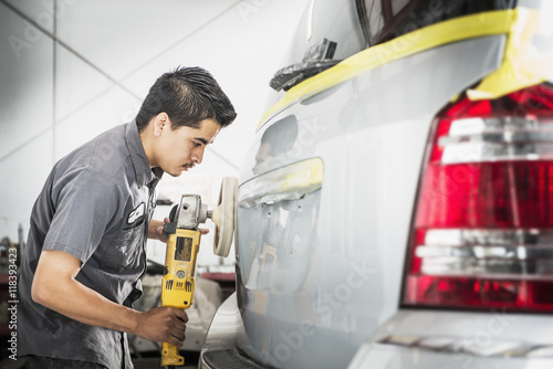 Hispanic mechanic working in auto shop photo