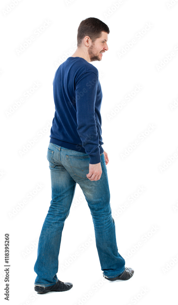 Back view of going handsome man. walking young guy . Rear view people collection. backside view of person. Isolated over white background. bearded man in blue pullover smile goes diagonally. Back view of going handsome man. walking young guy . Rear view people collection. backside view of person. Isolated over white background. bearded man in blue pullover smile goes diagonally.