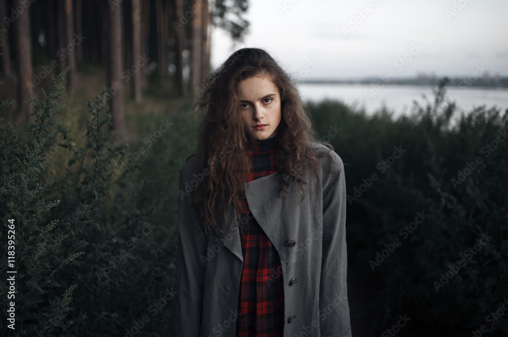 Caucasian woman standing in woods near lake Caucasian woman standing in woods near lake