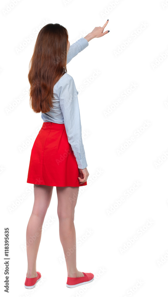 Back view of pointing woman. beautiful girl. Rear view people collection. backside view of person. Isolated over white background. Long-haired brunette in red skirt showing thumb up. Back view of pointing woman. beautiful girl. Rear view people collection. backside view of person. Isolated over white background. Long-haired brunette in red skirt showing thumb up.